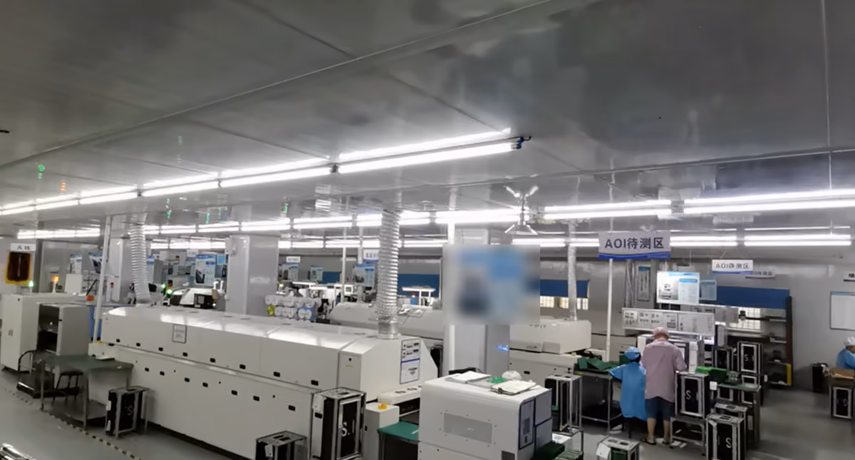 Automated SMT lines with reflow ovens and the AOI staging area at the AceTel production base